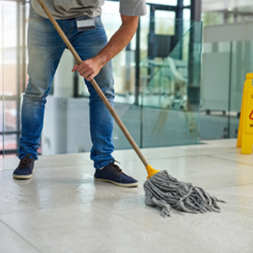 Man from one of the best cleaning companies in Peoria IL mopping floor