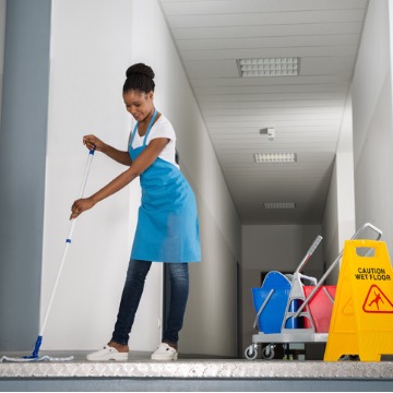Janitor in East Peoria IL Mopping a hallway