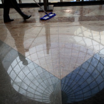 A janitor wiping down a floor during Deep Cleaning in Peoria IL