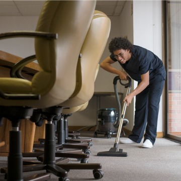 A Commercial Cleaning Company in East Peoria IL vacuuming the floor of a conference room