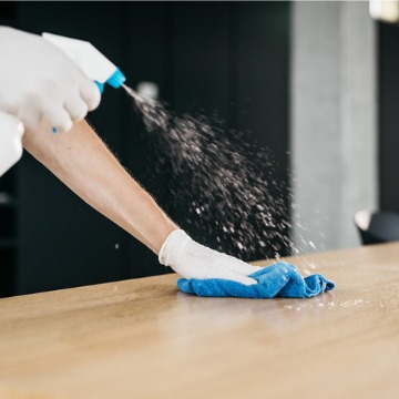 A cleaner wiping down surfaces during Corporate Cleaning Service in East Peoria IL