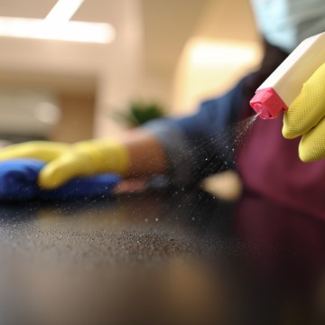 A team member of Corporate Clean washes a desktop as part of its Healthcare Cleaning in Dunlap IL.
