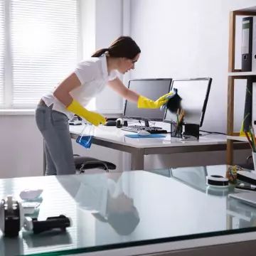 A cleaner is seen cleaning an office. The best office cleaning in Tazewell County IL is done by Corporate Clean.