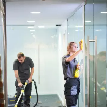 Cleaners are seen at work. Corporate Clean performs business cleaning in Peoria County IL.