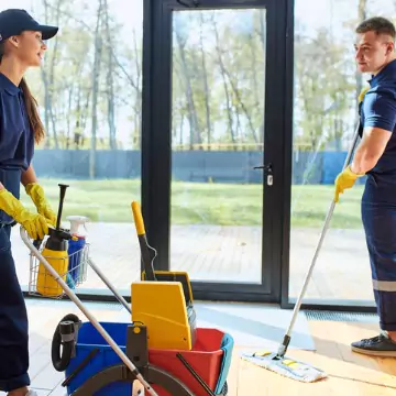 Cleaners are seen at work. Corporate Clean performs business cleaning in Peoria County IL.