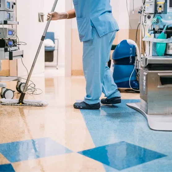A member of Corporate Clean mops as part of her work doing healthcare cleaning in an ER