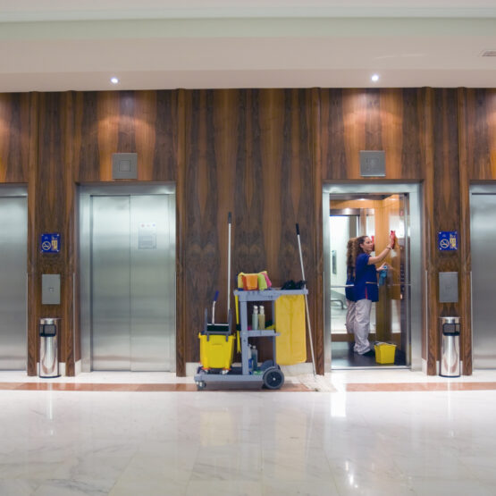 A women cleaning elevators in a building in East Peoria IL