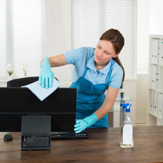 Young Woman In Workwear Rubbing Desktop Computer In Office in Dunlap IL