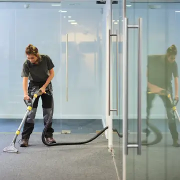 Industrial Cleaning vs Office Cleaning: How the Two are Different 1 A woman cleans floors in both Industrial Cleaning vs Office Cleaning scenarios